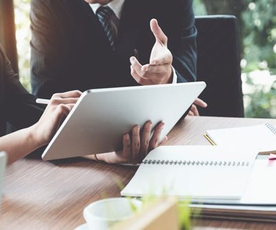 Business woman and lawyers discussing and using digital tablet  on wooden desk in office. Law, legal services, advice, Justice concept.